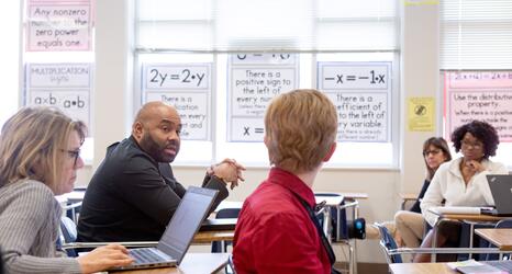 Sixth-grade math teachers discuss their lessons during a team planning session.