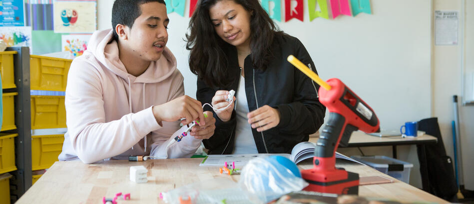 High schoolers work together to assemble a circuit kit in the school’s makerspace.