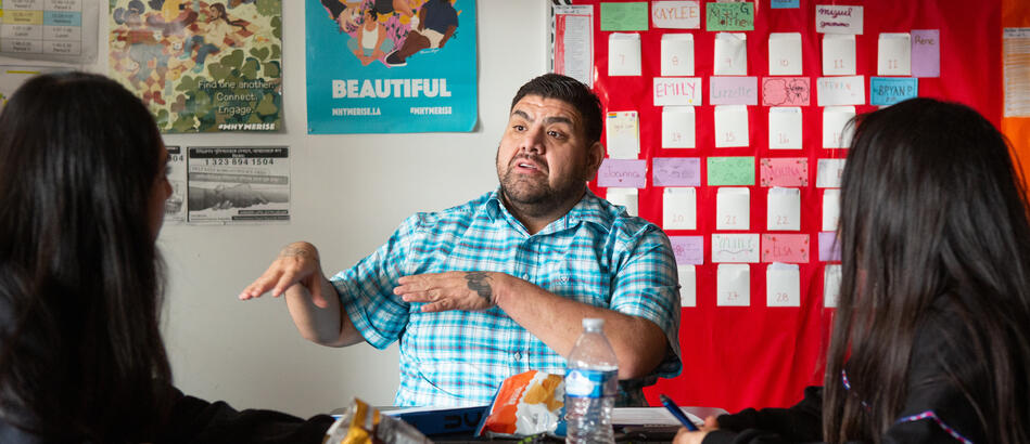 An undergraduate student from UCLA meets with high school students in an AP research class at UCLA Community School.