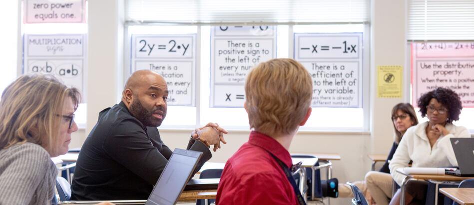 Sixth-grade math teachers discuss their lessons during a team planning session.