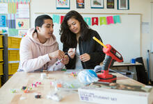 High schoolers work together to assemble a circuit kit in the school’s makerspace.